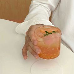 a person holding a drink in their hand