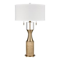 a table lamp with a white shade on it and a gold metal base, in front of a white background