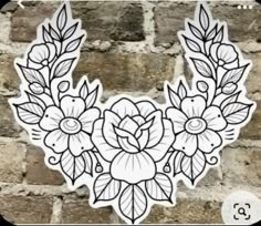 a sticker with flowers and leaves on the side of a brick wall in black and white