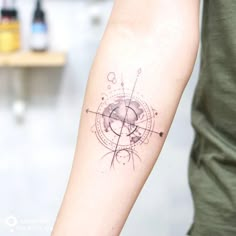 a person with a tattoo on their arm is looking at the camera and has an arrow in