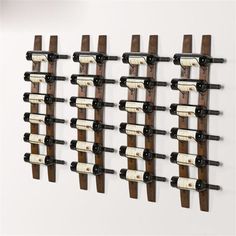 the wine rack is made out of wood and has several bottles hanging on it's sides