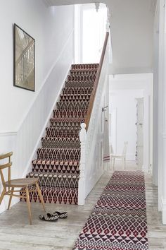 a stair case with carpeted stairs and rugs on the floor next to it