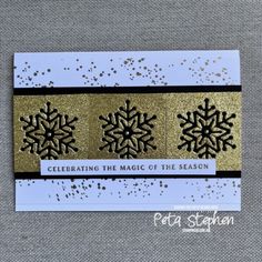 a card with gold and black snowflakes on it, saying celebrating the magic of the season