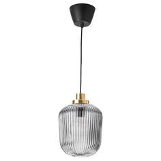 a glass and brass pendant light with a black cord hanging from the ceiling, on a white background