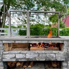 an outdoor fire pit is shown with logs