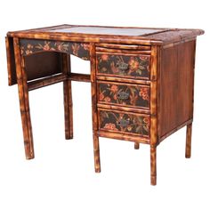 an antique desk with floral designs on the drawers and glass top is shown against a white background