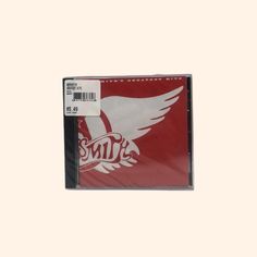 the cd case is red and has white wings on it