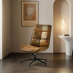 an office chair sitting on top of a hard wood floor next to a white table