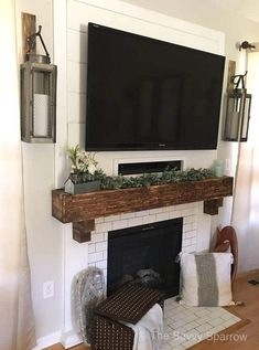 a flat screen tv mounted above a fireplace