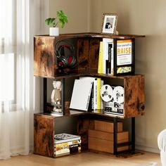 a bookshelf made out of wooden crates in a living room with a plant on top