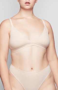 Enjoy the comfort of a bralette while retaining the breathability of quick-dry fabric with this comfortable option from Kim Kardashian West's SKIMS. Available in nine different shades, this second-skin triangle bra offers natural support and comfort while you read, lounge and sleep. Quick-dry, max-stretch technology Lined 79% polyamide, 21% spandex Hand wash, dry flat Imported Lingerie Micro-elastic Underwire Bra With Seamless Construction, Micro-elastic Seamless Shapewear Bra, Seamless Micro-elastic Shapewear Bra, Seamless No-show Micro-elastic Bra, Seamless Fitted Nursing Bra With Triangle Top, Adjustable Straps No-show Sports Bra, Adjustable Straps Micro-elastic Bra, Low-cut Sports Bra With Removable Pads, No-show Seamless Shapewear Bra