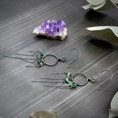 These earrings were created with emerald chips and sterling silver. I created the hoops out of 18 gauge sterling silver, and I created the earwires out of 20 gauge sterling silver.These earrings are 3” long at the longest point and each one weighs 1.4 grams. Sterling Silver Hoop Earrings For May Birthstone, Green Long Drop Sterling Silver Jewelry, Green Wire Wrapped Dangle Hoop Earrings, Green Wire-wrapped Dangle Hoop Earrings, Nickel-free Green Sterling Silver Hoop Earrings, Green Sterling Silver Hoop Earrings For May Birthstone, Green Small Hoop Metal Earrings, Green Sterling Silver Small Hoop Jewelry, Green Small Hoop Sterling Silver Jewelry