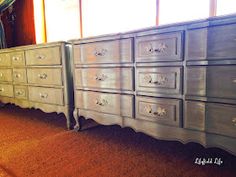 an old dresser is painted silver and has ornate knobs