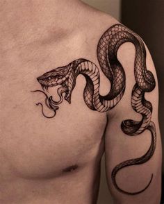 a man's chest with a snake tattoo on his arm and the other side