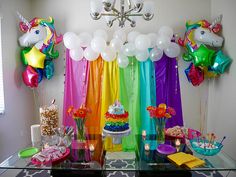 a rainbow themed party with balloons and decorations