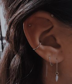 a close up of a person with ear piercings