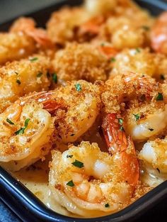 a pan filled with shrimp and bread crumbs