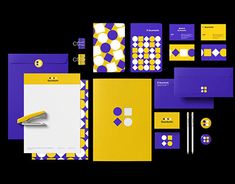 various stationery items are arranged on a black background with yellow and purple accents, including a fountain pen