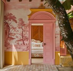 an open door leading to a bedroom with pink and yellow paint on the walls, in front of a tree