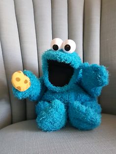 a blue stuffed animal sitting on top of a chair