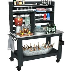 a bar cart with bottles and glasses on it