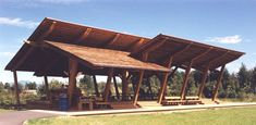 a large wooden structure with benches under it