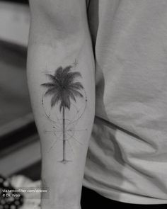 a man with a palm tree tattoo on his arm