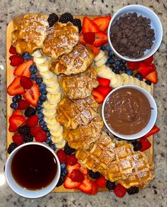 a platter with pastries, fruit and chocolate