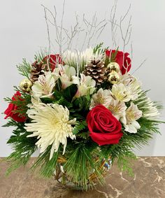 a vase filled with white and red flowers