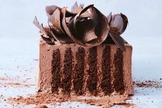 a piece of cake with chocolate frosting and spoons sticking out of the top