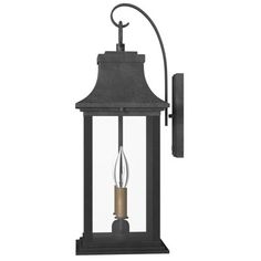 an outdoor wall light with a candle in the center and a black finish on it