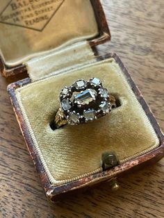 *RARE* and Collectable ~GEORGIAN 18k / Silver Antique TABLE Cut Diamond  Alternate Engagement Ring or Statement Ring Mid 1700's Estimate circa 1750 Just shy of Size 8 easily sizable by a skilled jeweler  All irregular and primitive cut TABLE Cut diamonds (RARE) measure 6x4.5 mm center approx.  Surrounding diamonds vary with an average of 3.75-4mm All table cut and appear original  Diamonds closed back & foiled , set in silver - customary for this period. IMPOSSIBLE to be accurate with the diamon Victorian Engraved Yellow Gold Ring With Rose Cut Diamonds, Victorian Ceremonial Ring With Rose Cut Diamonds, Victorian Rose Cut Diamond Ceremonial Rings, Ceremonial Yellow Gold Rings With Rose Cut Diamonds, Antique Diamond Ceremonial Rings, Antique Diamond Ring For Ceremonial Occasions, Antique Engraved Ring With Rose Cut Diamonds For Anniversary, Victorian Jewelry With Rose Cut Diamonds For Ceremonial Occasions, Victorian Engraved Wedding Ring With Rose Cut Diamonds