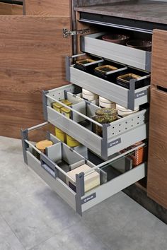 an open drawer in the middle of a kitchen