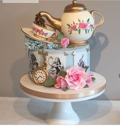 there is a cake decorated with teapots and flowers