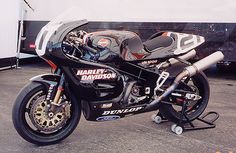 a motorcycle parked in front of a bus