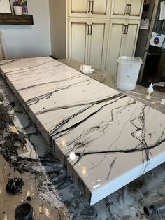 a kitchen counter that has been painted white and is being worked on by the same person