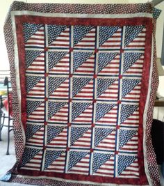 an american flag quilt on display in a room