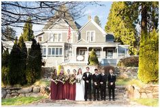 a group of people standing in front of a house