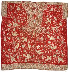 an old red and gold cloth with birds on it