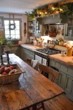 a wooden table sitting in a kitchen next to a stove top oven