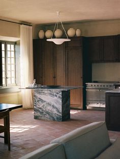 a living room and kitchen with marble counter tops