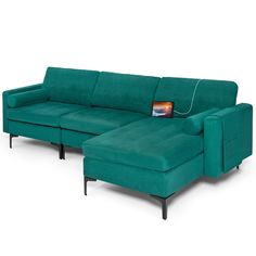 a green sectional sofa with a footstool in front of it and an ottoman on the back