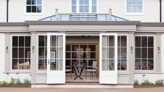 the front entrance to a house with french doors