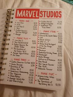 an open notebook with a list of things to do in the avengers studio on it