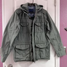 Tommy Hilfiger Men’s Green Military Jacket With Hood. Most Likely Never Worn, In Excellent Condition. Casual Tommy Hilfiger Outerwear With Pockets, Casual Winter Parka With Patch Pockets, Casual Tommy Hilfiger Outerwear For Spring, Tommy Hilfiger Casual Spring Outerwear, Casual Utility Jacket With Patch Pockets For Cold Weather, Casual Khaki Sport Coat For Cold Weather, Tommy Hilfiger Cotton Long Sleeve Outerwear, Tommy Hilfiger Hooded Outerwear With Pockets, Tommy Hilfiger Cotton Outerwear