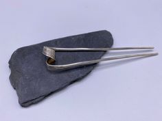 "The inspiration for this item comes from traditional Thai hairpin that women used to wear for special occasions, such as Thai festivals, Thai dance or weddings.  It is made of a single solid silver piece, hammered to create textures in the middle part, that is twisted and folded into the final shape of the hairpin. Simple yet sophisticated, you can use it as an everyday detail as well as that \"something special\" piece to make your hairdo stand out."