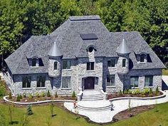 an aerial view of a large stone house