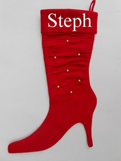 a pair of red boots with pearls on the bottom and one boot is made out of fabric