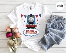 a t - shirt that says harry is turning 3 with a train on the front