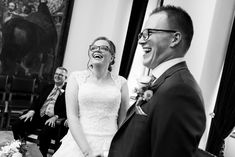 a bride and groom laughing at each other